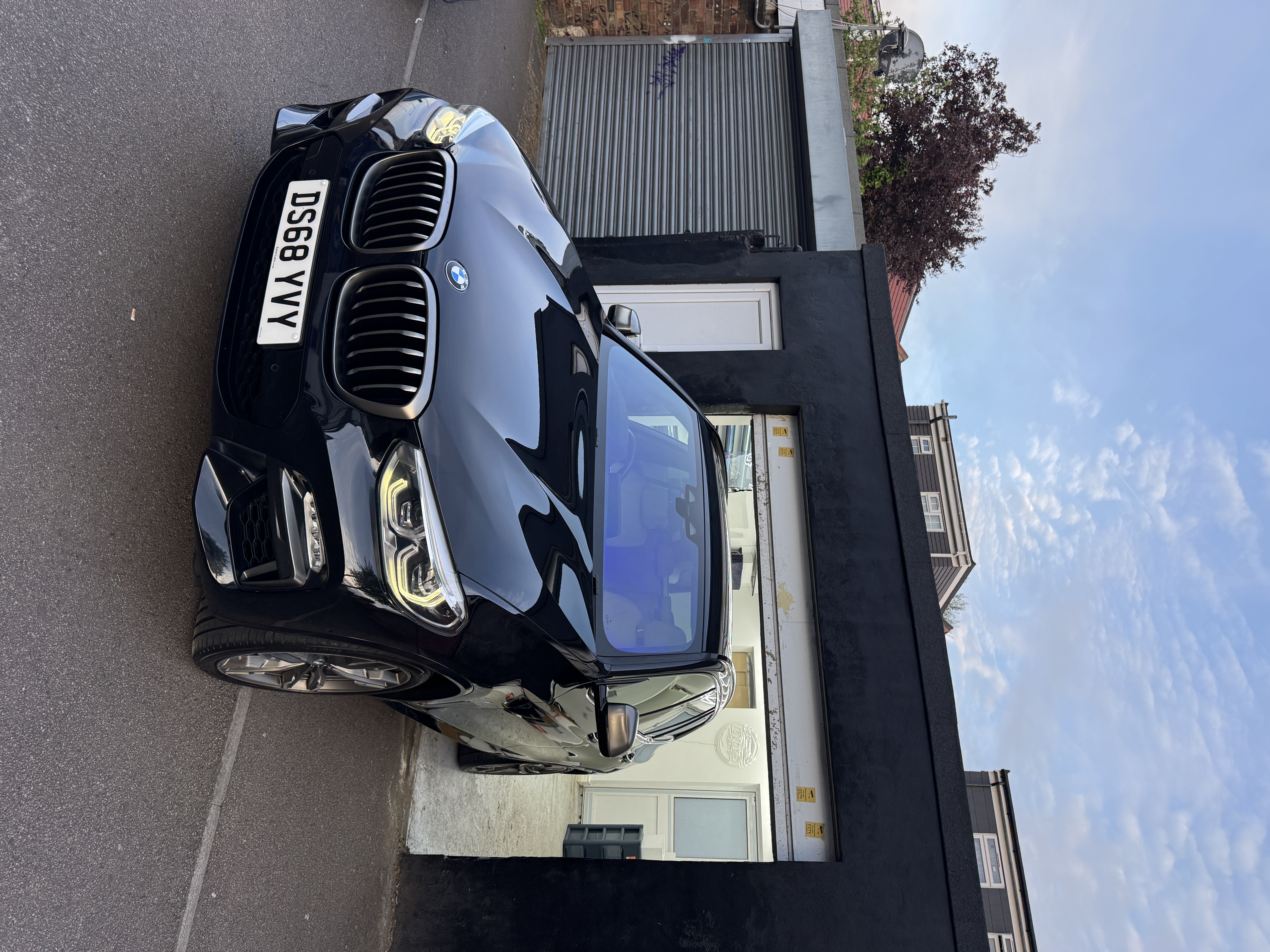 Black BMW X3 M40i parked outside the DOS Tints shop